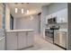 Kitchen with stainless steel appliances, quartz countertops and open to the living area at 9516 Woodborough Ct, Tampa, FL 33615