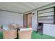 Covered outdoor patio featuring wicker seating and view to the backyard at 9516 Woodborough Ct, Tampa, FL 33615