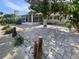 Lush backyard with a screen porch and manicured landscaping at 5511 Drinkard Dr, New Port Richey, FL 34653