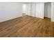 Bedroom features a closet, ensuite access, and wood-look flooring at 5511 Drinkard Dr, New Port Richey, FL 34653
