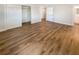 Bedroom features a closet, ensuite access, and wood-look flooring at 5511 Drinkard Dr, New Port Richey, FL 34653