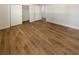 Bedroom features a closet, ensuite access, and wood-look flooring at 5511 Drinkard Dr, New Port Richey, FL 34653