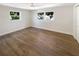 Bright bedroom features two windows for natural light and a ceiling fan at 5511 Drinkard Dr, New Port Richey, FL 34653