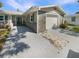 A single-Gathering home boasts stone accents, a one-car garage, and a walkway to the front door at 5511 Drinkard Dr, New Port Richey, FL 34653