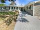 Charming single-story home featuring a stone facade and brick driveway, complemented by verdant landscaping at 5511 Drinkard Dr, New Port Richey, FL 34653