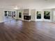 Spacious living room with sleek hardwood floors and a cozy fireplace at 5511 Drinkard Dr, New Port Richey, FL 34653