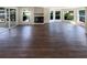 Open-concept living room with beautiful hardwood floors, a fireplace, and water view at 5511 Drinkard Dr, New Port Richey, FL 34653