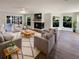 Bright and airy living room showcasing hardwood floors, a fireplace, and abundant natural light at 5511 Drinkard Dr, New Port Richey, FL 34653