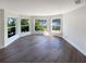 Bright living room with hardwood floors, a bay window overlooking the lake at 5511 Drinkard Dr, New Port Richey, FL 34653