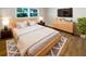 Comfortable main bedroom featuring a cozy bed, stylish decor, and ample natural light at 5511 Drinkard Dr, New Port Richey, FL 34653