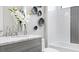 Elegant bathroom with a marble countertop, decorative tile, and modern fixtures at 14375 Hammock Oak St, Parrish, FL 34219