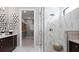 Modern bathroom featuring a walk-in shower with marble-like tile and access to a spacious walk-in closet at 14375 Hammock Oak St, Parrish, FL 34219