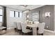 Elegant dining room with modern lighting, neutral decor, and a brick accent wall at 14375 Hammock Oak St, Parrish, FL 34219