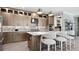 Sophisticated kitchen featuring modern appliances, stylish pendant lighting, island seating, and elegant cabinetry at 14375 Hammock Oak St, Parrish, FL 34219