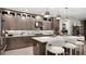 Stylish kitchen features sleek cabinets, stainless steel appliances, island with seating, and designer lighting fixtures at 14375 Hammock Oak St, Parrish, FL 34219