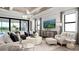 Bright living room with modern decor, a television, and access to an outdoor living area at 14375 Hammock Oak St, Parrish, FL 34219