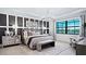 Serene main bedroom with large windows, a stylish chandelier, textured walls, and sophisticated decor at 14375 Hammock Oak St, Parrish, FL 34219