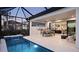 Inviting outdoor space with a pool, grilling area, dining set, and cozy seating at 14375 Hammock Oak St, Parrish, FL 34219