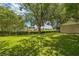Expansive back yard with lush green grass and mature trees, perfect for outdoor activities and relaxation at 2002 Culpepper Dr, Brandon, FL 33511