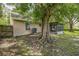 A spacious backyard with a large tree and a screened-in porch offers a peaceful outdoor living space at 2002 Culpepper Dr, Brandon, FL 33511