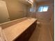 A full bathroom with a large vanity and shower-tub combo presents a clean and functional space at 2002 Culpepper Dr, Brandon, FL 33511