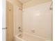 Standard bathroom featuring white tiling, a bathtub and shower, and a neutral color scheme at 2002 Culpepper Dr, Brandon, FL 33511