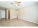 Large bedroom with tile flooring, a vaulted ceiling, a ceiling fan, and multiple closets at 2002 Culpepper Dr, Brandon, FL 33511