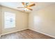 Bedroom with wood flooring, ceiling fan, and a window with natural light at 2002 Culpepper Dr, Brandon, FL 33511