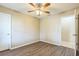 This spacious bedroom includes wood-look flooring, a ceiling fan, and access to the hallway at 2002 Culpepper Dr, Brandon, FL 33511