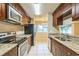 A functional kitchen offers granite countertops, stainless steel appliances, and direct access to the dining area at 2002 Culpepper Dr, Brandon, FL 33511