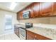 This updated kitchen features granite countertops and stainless steel appliances for a modern culinary experience at 2002 Culpepper Dr, Brandon, FL 33511