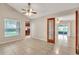 A bright living room with tile floors, ceiling fan, and a view into the kitchen makes for easy living at 2002 Culpepper Dr, Brandon, FL 33511