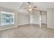 Neutral living space featuring tile floors, high ceilings, and a large window at 2002 Culpepper Dr, Brandon, FL 33511