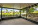 Relaxing screened-in porch with a view of the serene pond and lush landscaping, ideal for outdoor living at 2002 Culpepper Dr, Brandon, FL 33511