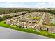 Aerial view showcases a neighborhood with houses, green spaces, and a waterfront area at 4704 Wild Senna Blvd, Tampa, FL 33619