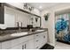 Elegant bathroom with dual sinks, granite countertops, a large mirror, and stylish decor at 4704 Wild Senna Blvd, Tampa, FL 33619