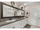 Bright bathroom features double sinks, granite counters, a large mirror, and white cabinets at 4704 Wild Senna Blvd, Tampa, FL 33619