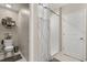 A well-lit bathroom features a toilet, shower, and a storage area, designed for comfort and functionality at 4704 Wild Senna Blvd, Tampa, FL 33619