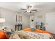 Inviting bedroom with a comfortable bed, side table, ceiling fan, and a serene ambiance at 4704 Wild Senna Blvd, Tampa, FL 33619