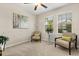 Bright bedroom with natural light, neutral tones, and cozy seating by the windows, offering a relaxing space at 4704 Wild Senna Blvd, Tampa, FL 33619