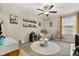 Neutral bedroom featuring stylish decorations, a ceiling fan, and a comfortable beanbag chair at 4704 Wild Senna Blvd, Tampa, FL 33619