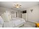 Neutral bedroom featuring a ceiling fan, TV and a glimpse into the bathroom at 4704 Wild Senna Blvd, Tampa, FL 33619