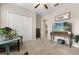 A bright bedroom featuring a closet, an entertainment center, and natural lighting from an adjacent room at 4704 Wild Senna Blvd, Tampa, FL 33619