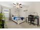 Bright bedroom features white furniture, ocean inspired decor, and a dedicated desk area at 4704 Wild Senna Blvd, Tampa, FL 33619
