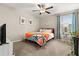 Comfortable bedroom featuring ocean inspired decor, desk area, and a ceiling fan at 4704 Wild Senna Blvd, Tampa, FL 33619
