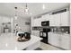 A kitchen featuring white cabinets, subway tile, and a quartz countertop at 4704 Wild Senna Blvd, Tampa, FL 33619