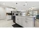 Bright kitchen with stainless steel appliances, a center island, and sleek white cabinetry at 4704 Wild Senna Blvd, Tampa, FL 33619