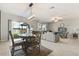 Open concept living and dining area offering great natural light and seamless transition to an outdoor screened space at 4704 Wild Senna Blvd, Tampa, FL 33619