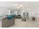 Bright living room with a comfortable gray sectional, plush rug, ceiling fan, and a view of the outdoors at 4704 Wild Senna Blvd, Tampa, FL 33619