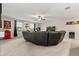 Spacious living area with a large sectional sofa, TV, and ceiling fan, ideal for entertainment and relaxation at 4704 Wild Senna Blvd, Tampa, FL 33619